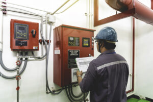 Engineer checking industrial generator fire control system