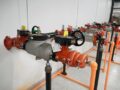 Why are backflow preventers required in fire sprinkler systems?